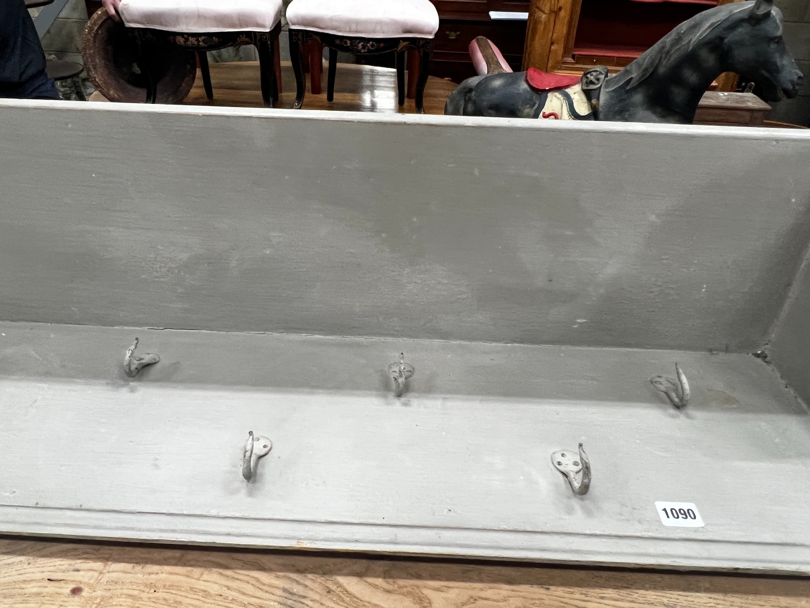 A painted hanging coat rack with wrought iron hooks, length 182cm, height 28cm